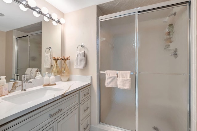 bathroom with vanity and a shower with door