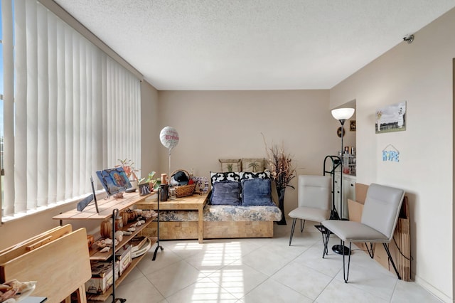 living area with light tile patterned floors and a textured ceiling