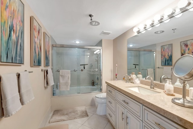 full bathroom with tile patterned flooring, vanity, toilet, and combined bath / shower with glass door