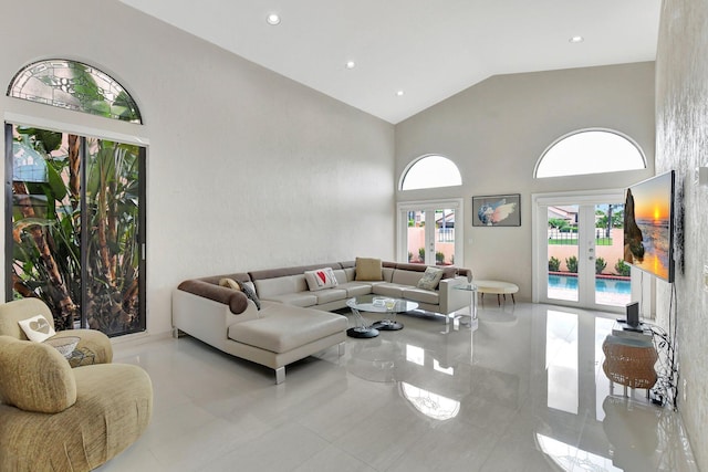 living room featuring french doors and high vaulted ceiling