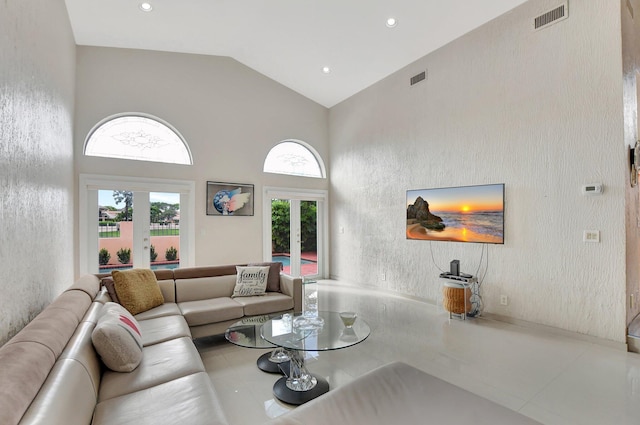 living room with french doors, high vaulted ceiling, and a wealth of natural light