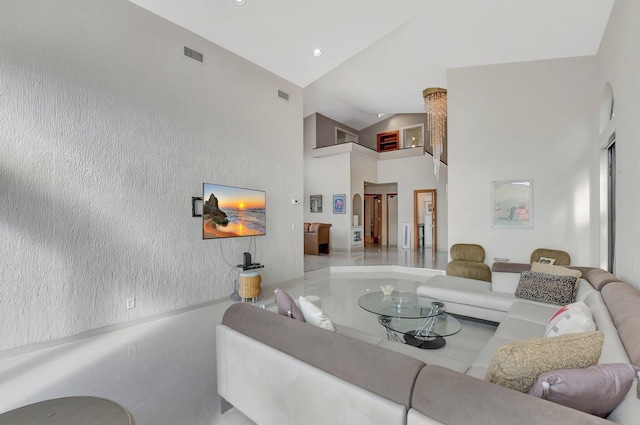 living room featuring high vaulted ceiling