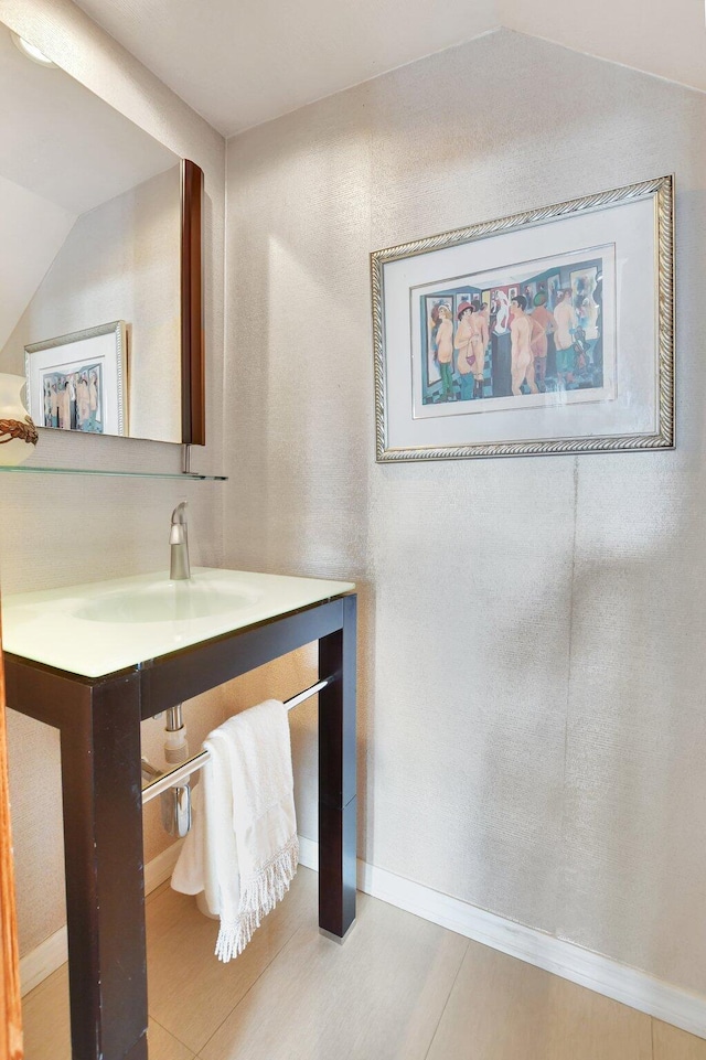 bathroom with vanity, tile patterned floors, and lofted ceiling