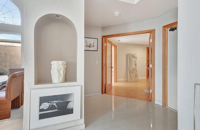 hallway featuring light tile patterned flooring