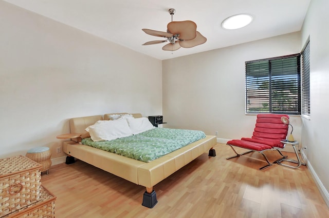 bedroom with wood-type flooring and ceiling fan