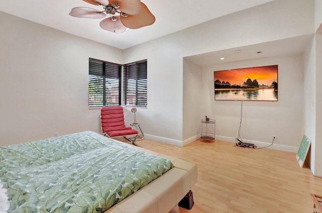 bedroom with ceiling fan and hardwood / wood-style flooring