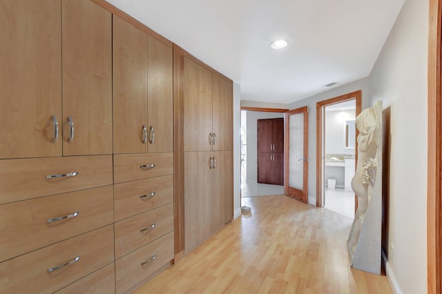 corridor with light wood-type flooring