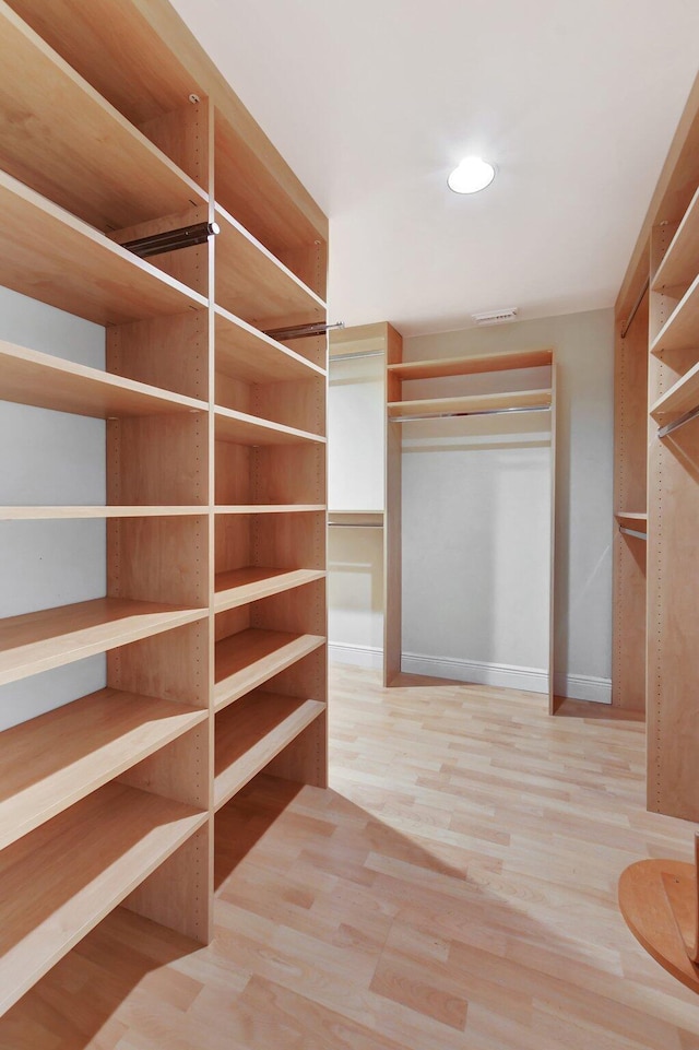 walk in closet featuring hardwood / wood-style floors