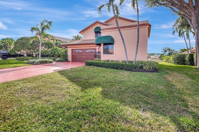 mediterranean / spanish-style home with a front yard and a garage