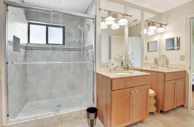 bathroom with tile patterned flooring, vanity, and walk in shower