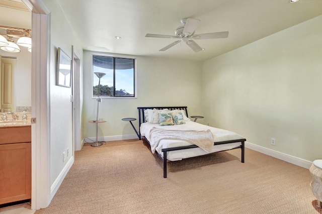 bedroom featuring light carpet, ceiling fan, and sink