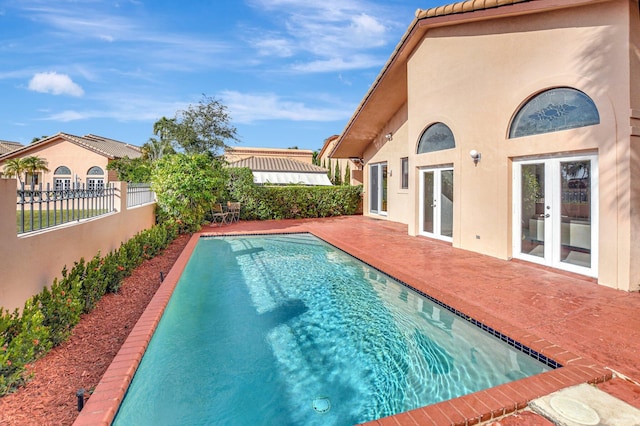 view of pool featuring a patio area and french doors