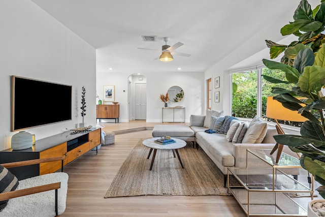 living area with arched walkways, recessed lighting, visible vents, a ceiling fan, and wood finished floors