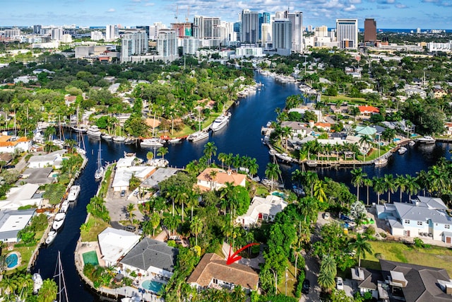 birds eye view of property with a water view and a city view