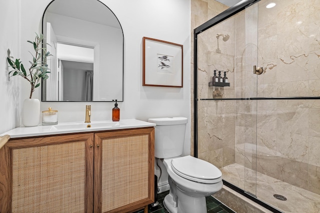 full bathroom with toilet, a shower stall, and vanity