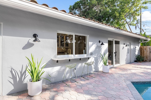 exterior space with fence and outdoor dry bar