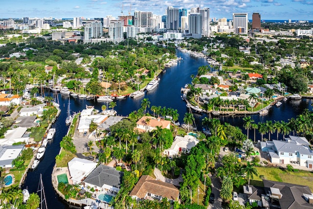 birds eye view of property with a water view and a city view