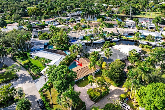 birds eye view of property with a water view and a residential view