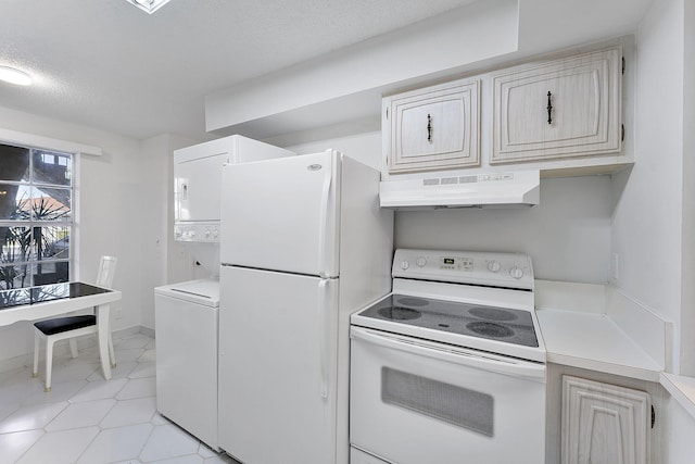 kitchen with a textured ceiling, white appliances, and stacked washer / dryer