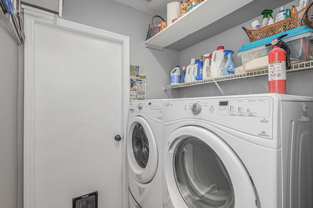 laundry area featuring washer and dryer and a textured ceiling