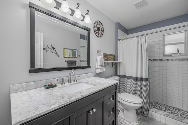 bathroom with tile patterned floors, vanity, toilet, and walk in shower