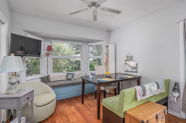 office space featuring hardwood / wood-style floors, ceiling fan, and a textured ceiling