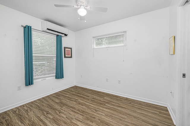 empty room with a wall mounted air conditioner, ceiling fan, and dark wood-type flooring