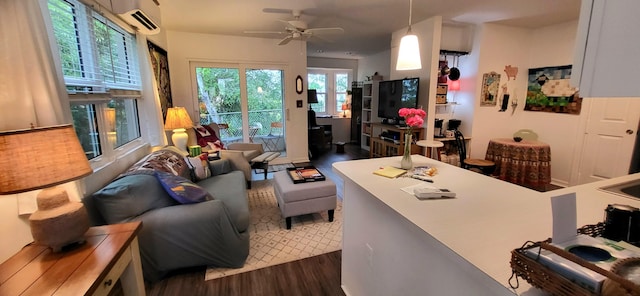 interior space with a wall mounted AC, ceiling fan, and dark wood-type flooring