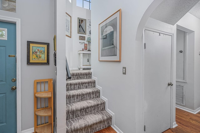 stairs with hardwood / wood-style flooring