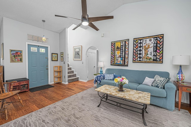 living room featuring a textured ceiling, hardwood / wood-style flooring, high vaulted ceiling, and ceiling fan