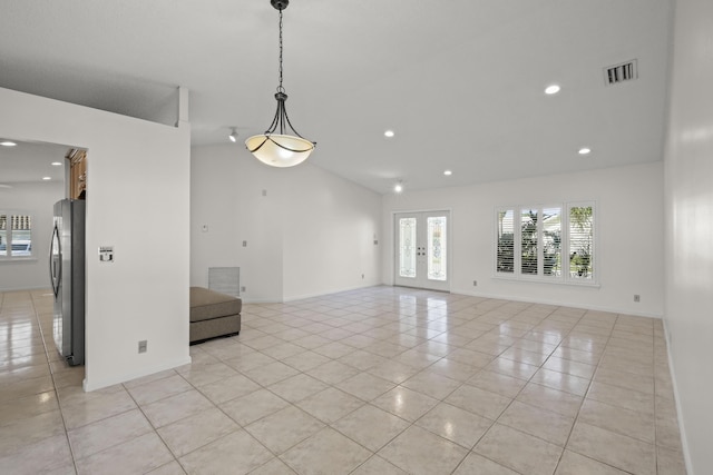 unfurnished room featuring light tile patterned floors and lofted ceiling