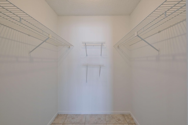 spacious closet featuring light tile patterned floors