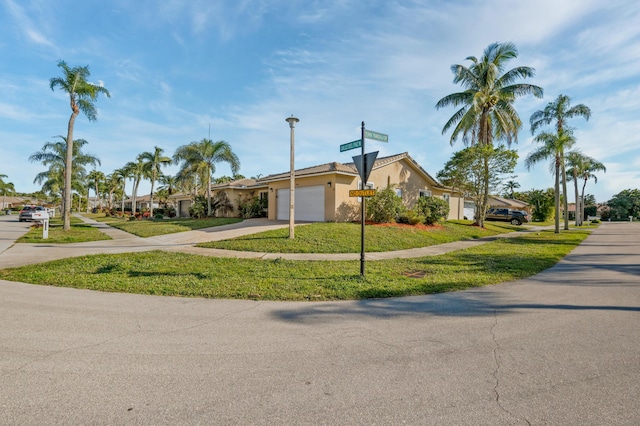 ranch-style house with a garage and a front lawn