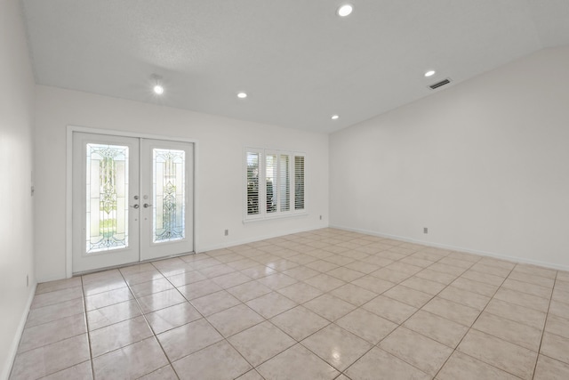 spare room with french doors and light tile patterned floors