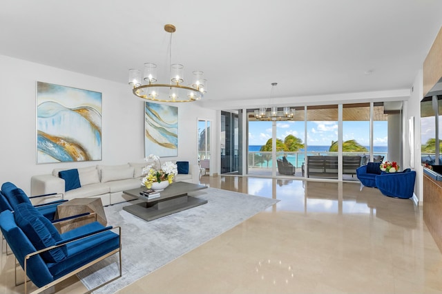 living room with a water view, an inviting chandelier, and expansive windows