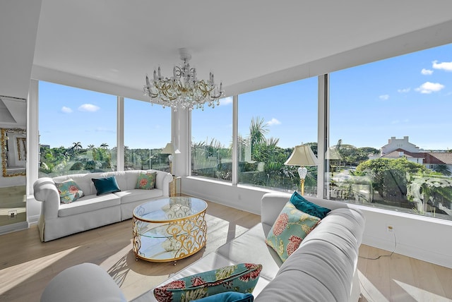 sunroom / solarium with a chandelier