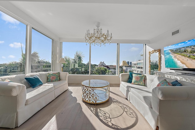 sunroom / solarium with a chandelier