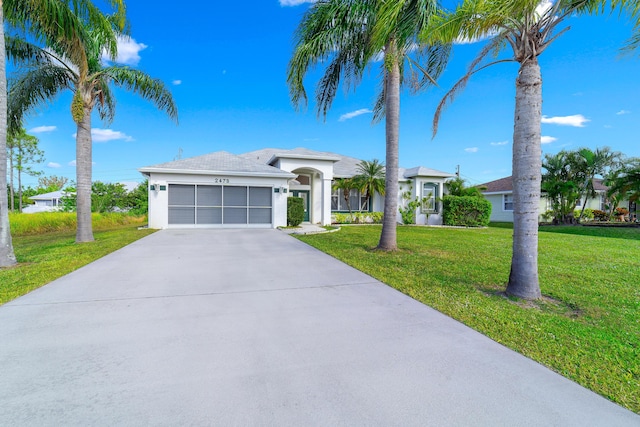 single story home with a garage and a front lawn