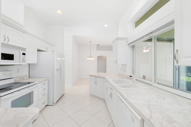 kitchen featuring pendant lighting, white appliances, white cabinetry, and sink