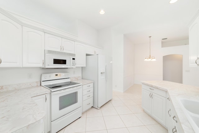 kitchen with a notable chandelier, white cabinetry, white appliances, and hanging light fixtures