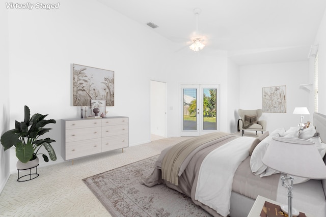 carpeted bedroom with ceiling fan and french doors