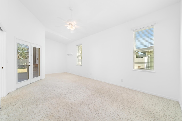 carpeted empty room with a wealth of natural light, french doors, and ceiling fan