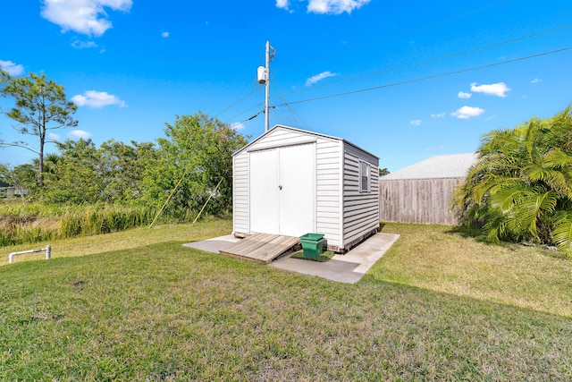 view of outbuilding with a yard