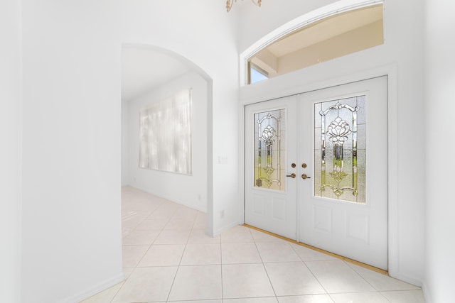 tiled foyer entrance featuring french doors