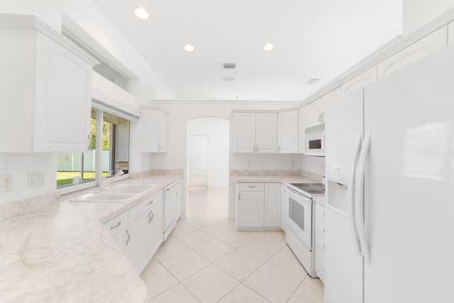 kitchen featuring white cabinetry, white appliances, sink, and light tile patterned floors