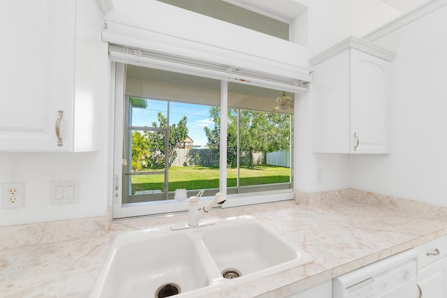 kitchen featuring white cabinets, sink, and white dishwasher