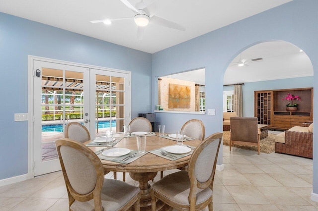 tiled dining room featuring french doors and ceiling fan