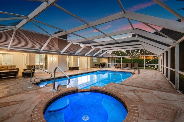 view of swimming pool featuring a lanai and a patio