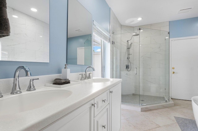 bathroom with vanity, tile patterned floors, and a shower with door