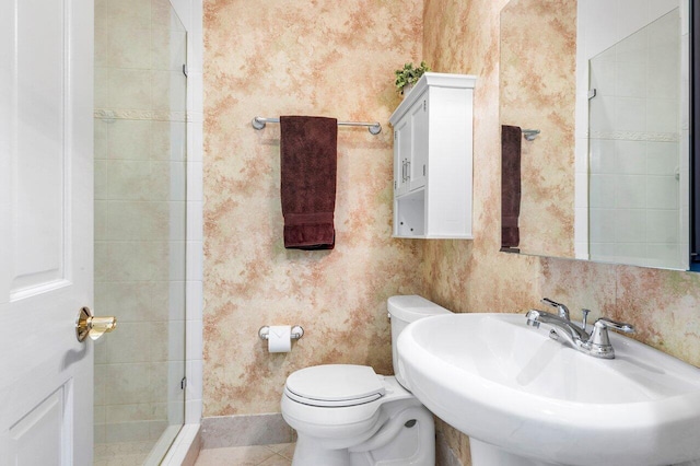 bathroom featuring tile patterned floors, toilet, and sink